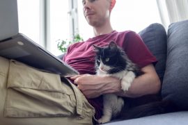 A man comfortably working from home as distributed AI Teams 